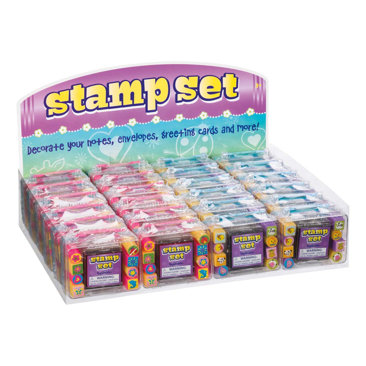 A Toysmith Mini Stamp Sets display box holds multiple colorful craft stamps in pink, purple, blue, and green packaging. The sign suggests using them for creative play with notes, envelopes, greeting cards, and more. Brand: Toysmith.