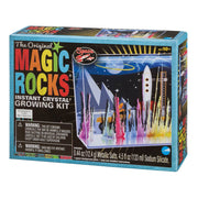A box of NSI’s The Original Magic Rocks Deluxe Crystal Growing Kit, for ages 10+, features colorful crystals, a white rocket, and planets on the package with included warnings and product details.
