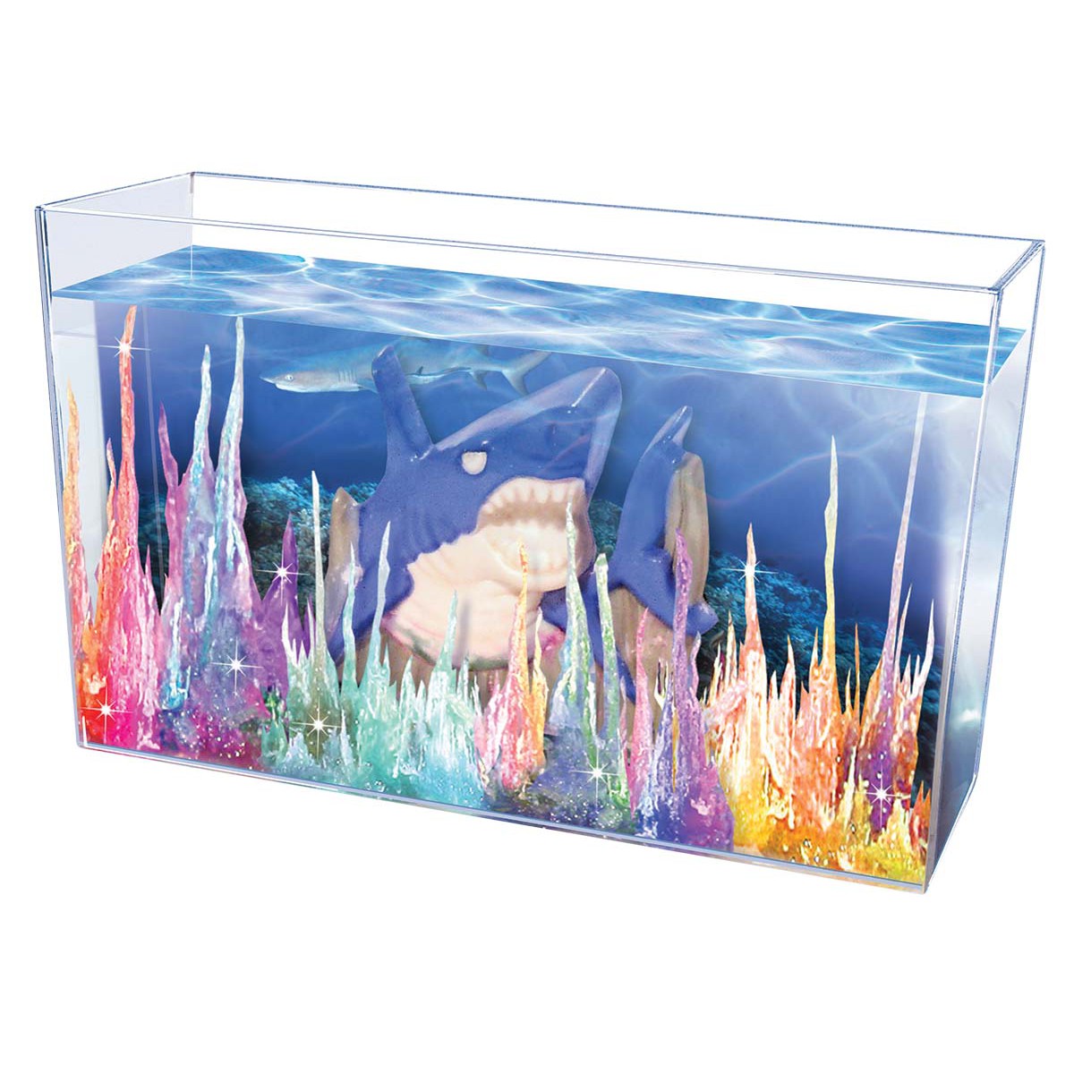 The NSI Original Magic Rocks Deluxe Crystal Growing Kit features colorful crystal formations and a large blue shark figure set in a blue underwater scene—perfect for imaginative play and instant crystal growing fun.