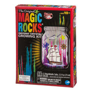 Front of an NSI The Original Magic Rocks Crystal Growing Kit box, featuring colorful ocean-themed crystals in a jar with ship and sea stickers. Kit is for ages 10+ and includes a warning about swallowing.