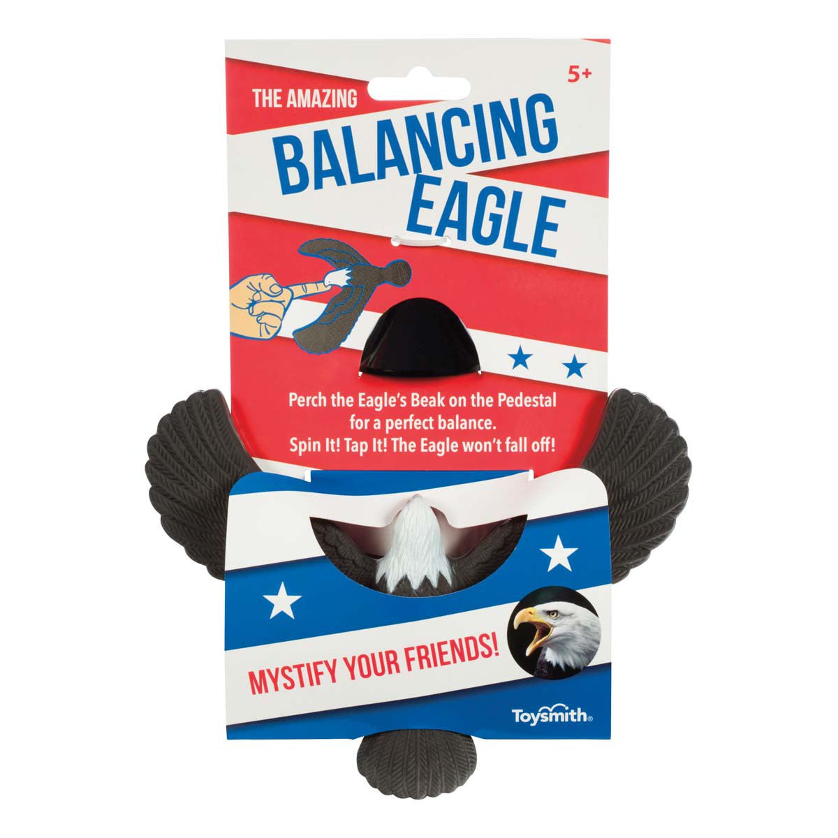 Packaging for the Toysmith Balancing Eagle magic toy features a black eagle balanced by its beak on a pedestal. The red, white, and blue design with stars and bold text highlights that it’s suitable for ages 5 and up. Brand: Toysmith.