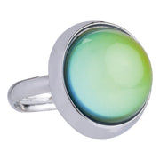 The Toysmith Jumbo Mood Ring by Toysmith is a silver ring with a round, domed stone that shifts from green to blue and yellow, resembling classic adjustable color-changing rings.