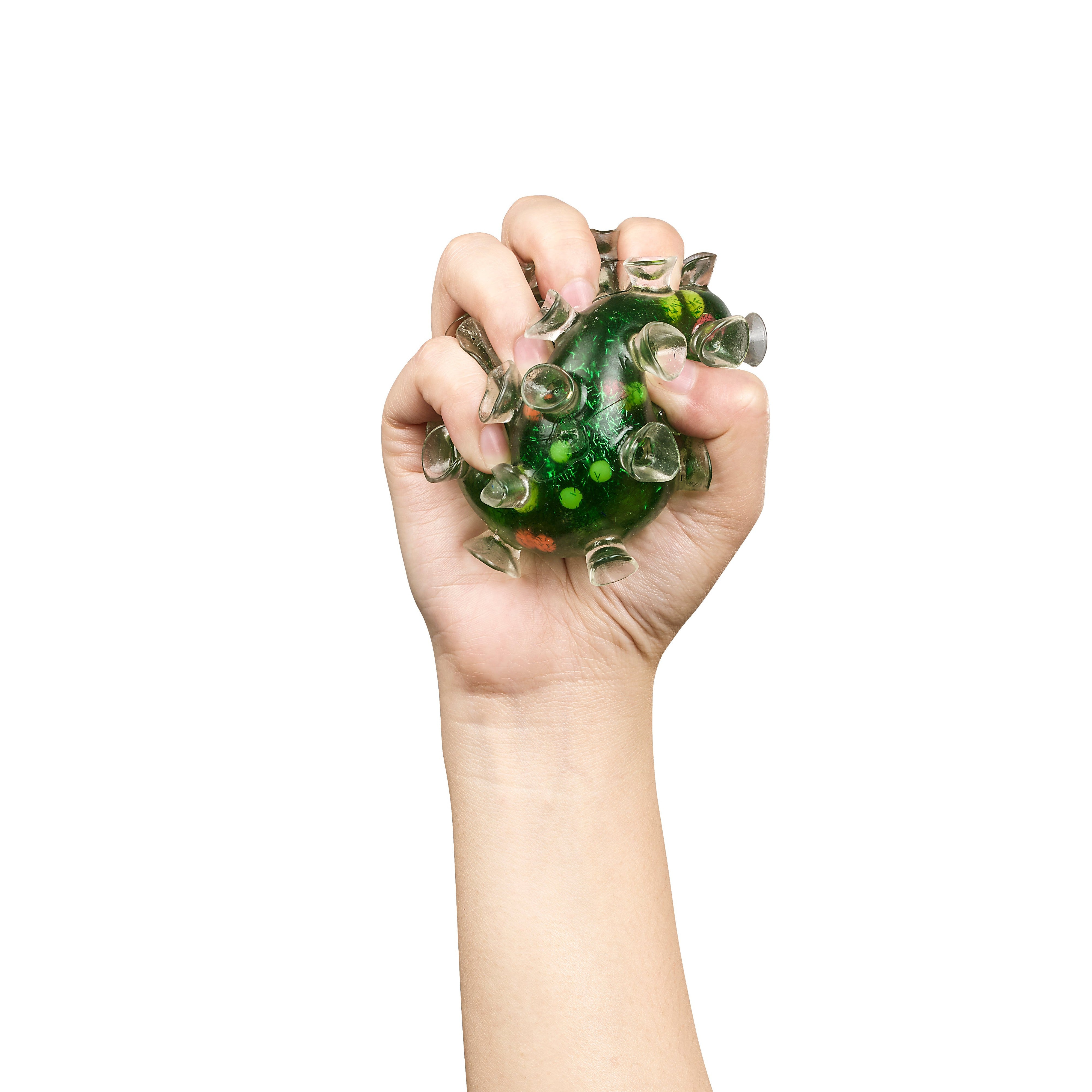 A hand tightly squeezes the Toysmith Squishy Sucker Ball by Toysmith—a green, spiky sensory toy with transparent suction cup protrusions—against a white background.