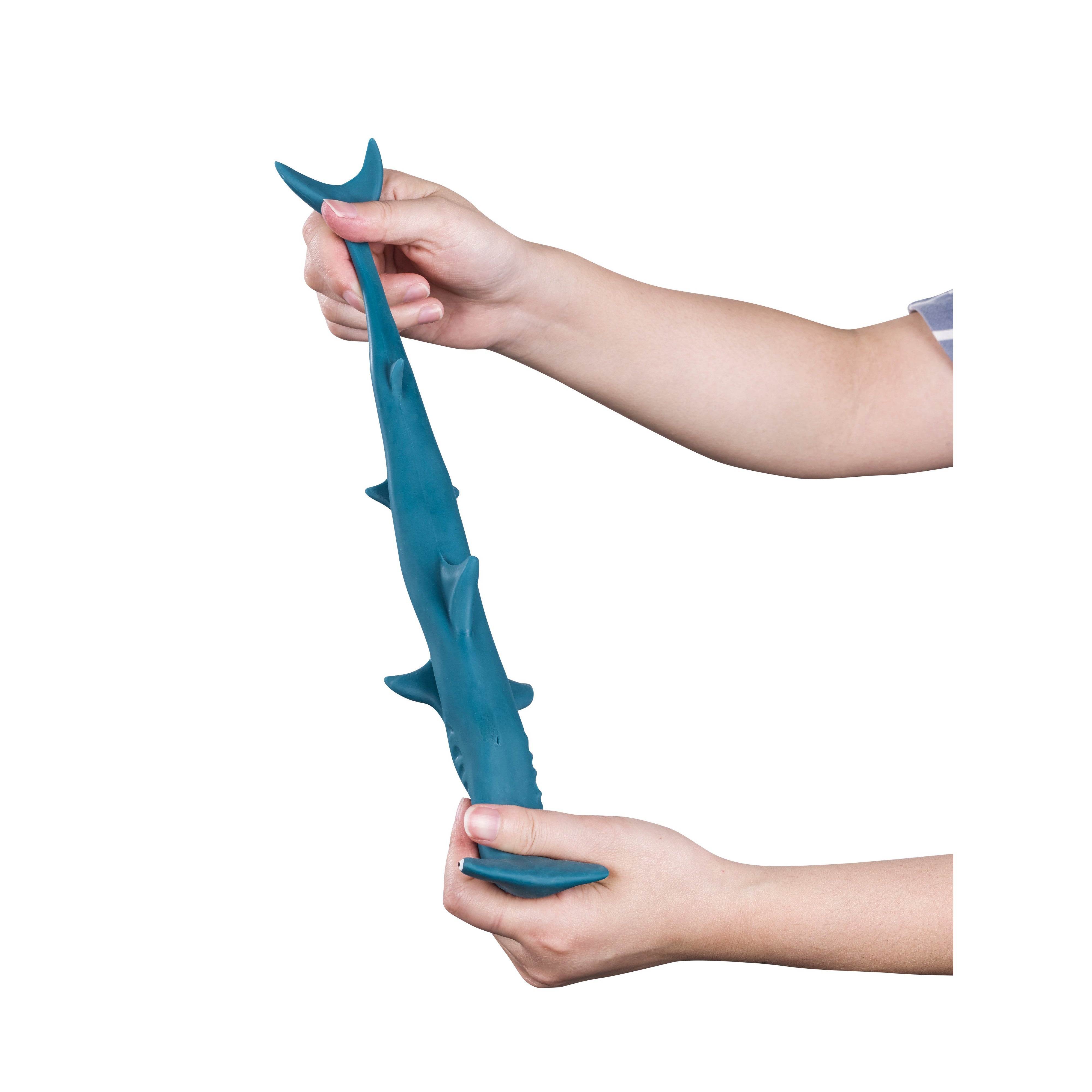 Two hands stretch a blue, rubbery shark from the Toysmith Super Stretchy Sand Filled Sea Life collection against a white background—a fun sensory toy by Toysmith inspired by ocean creatures.