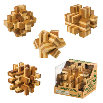 Five Toysmith Bamboozlers Puzzle Asst brainteasers are shown, crafted from light and dark bamboo. Four are assembled and one is boxed, all designed by Toysmith to boost problem-solving skills.
