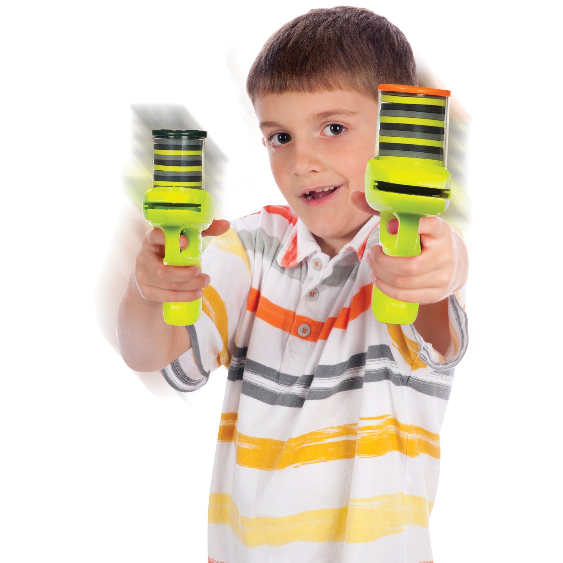 A smiling young boy in a striped shirt spins two Lanard Duel Zip Shot Twin Pack foam shooters, one in each hand, creating exciting motion blurs during this outdoor scene with Lanard’s fun shooting toys.