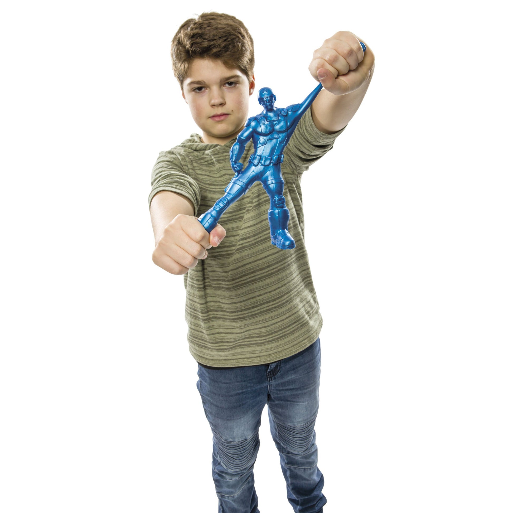 A boy in a green striped shirt and jeans holds out the Toysmith Epic Stretch Hero by Toysmith with both hands, ready for action-packed fun against a white background.