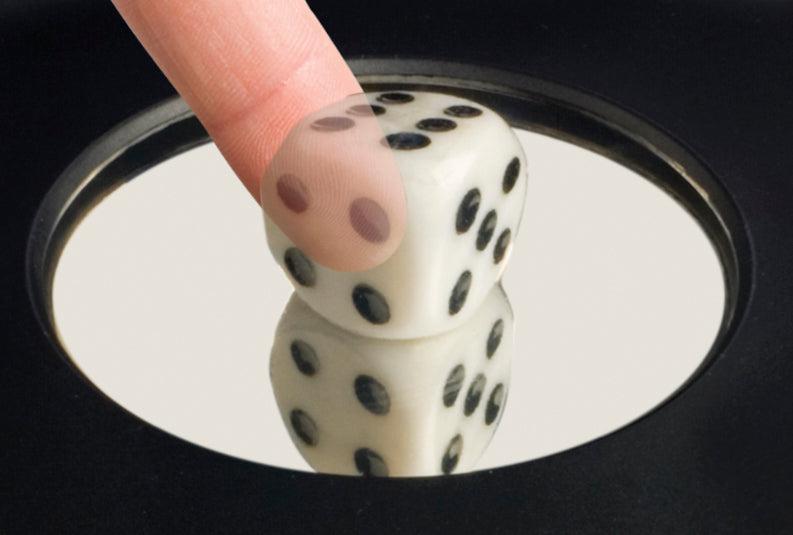 Touching the Toy Science 3-D Mirascope by Toy Science creates an optical illusion, projecting a hovering image of a white die with black dots that appear real when viewed above the device’s mirror-like surface.
