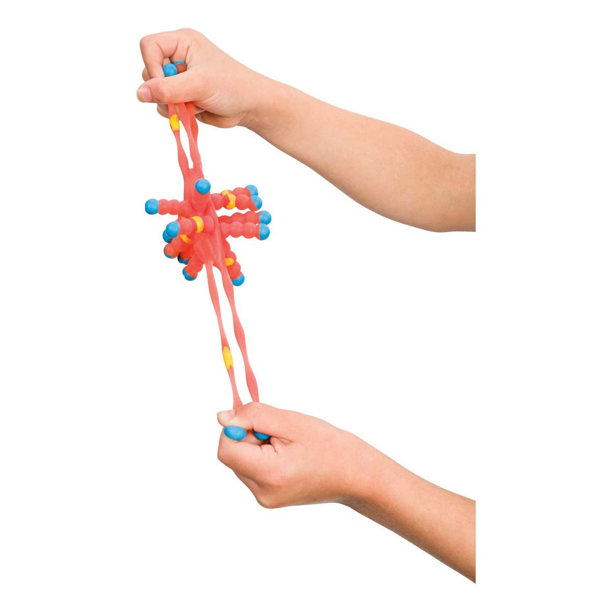 Two hands stretch the Toysmith Colorful Atom Ball, a spiky, rubbery fidget toy with blue, yellow, and red parts from the brand Toysmith, against a white background.