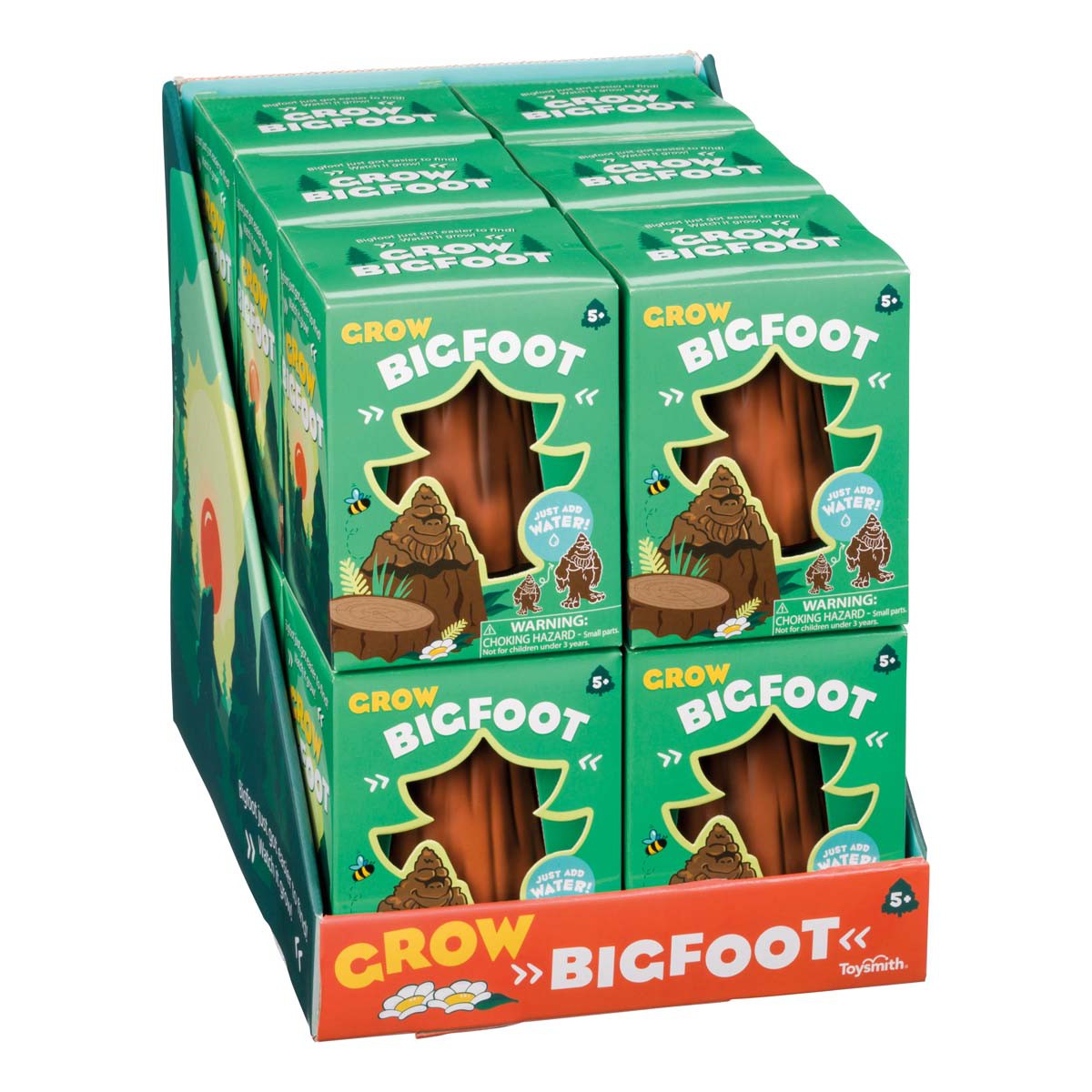 A Toysmith display box holds several green Toysmith Grow Bigfoot packages, each featuring a cartoon Bigfoot and stating the toy grows in water. The box’s bottom boldly reads "Grow Bigfoot.