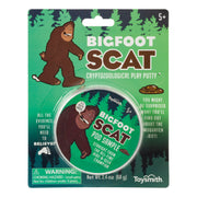 Toysmith Bigfoot Scat by Toysmith is a playful fake poop toy packaged in a round container with cartoon Bigfoot art. The green box features trees, safety warnings, an age recommendation, and fun text.